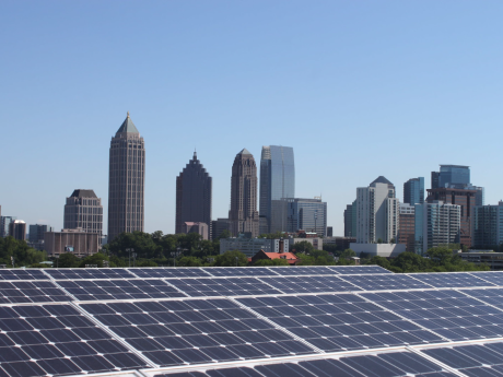 Recycling and Sustainability Solar panels with skyline of buildings behind