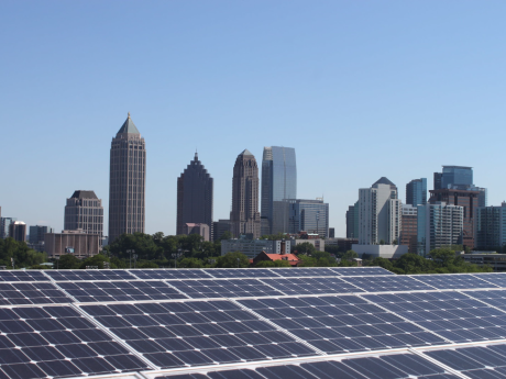 Solar panels with skyline of buildings behind