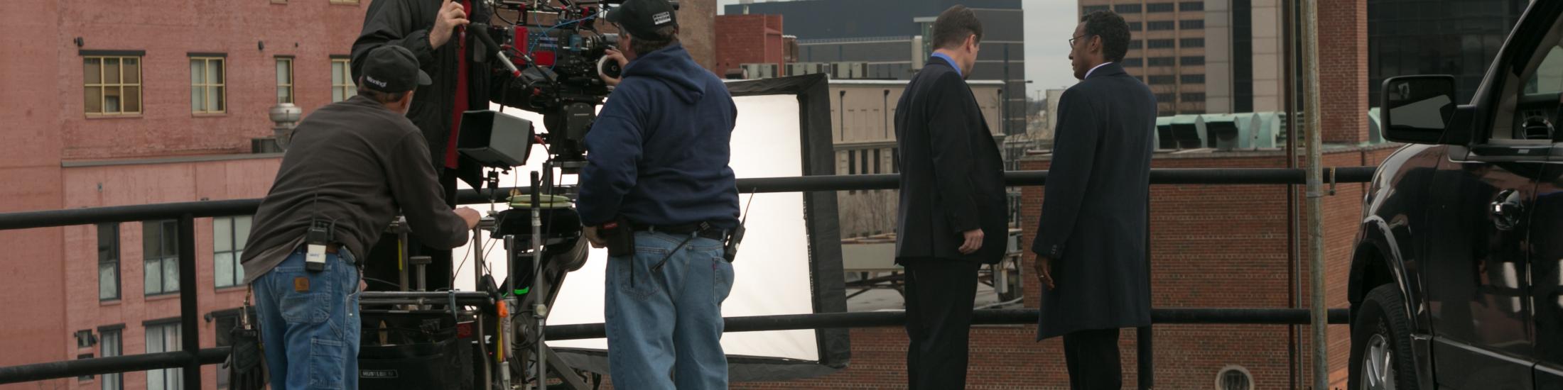 Five men on set outside on a rooftop filming in Georgia