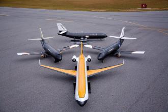 A group of planes sit on a runway.