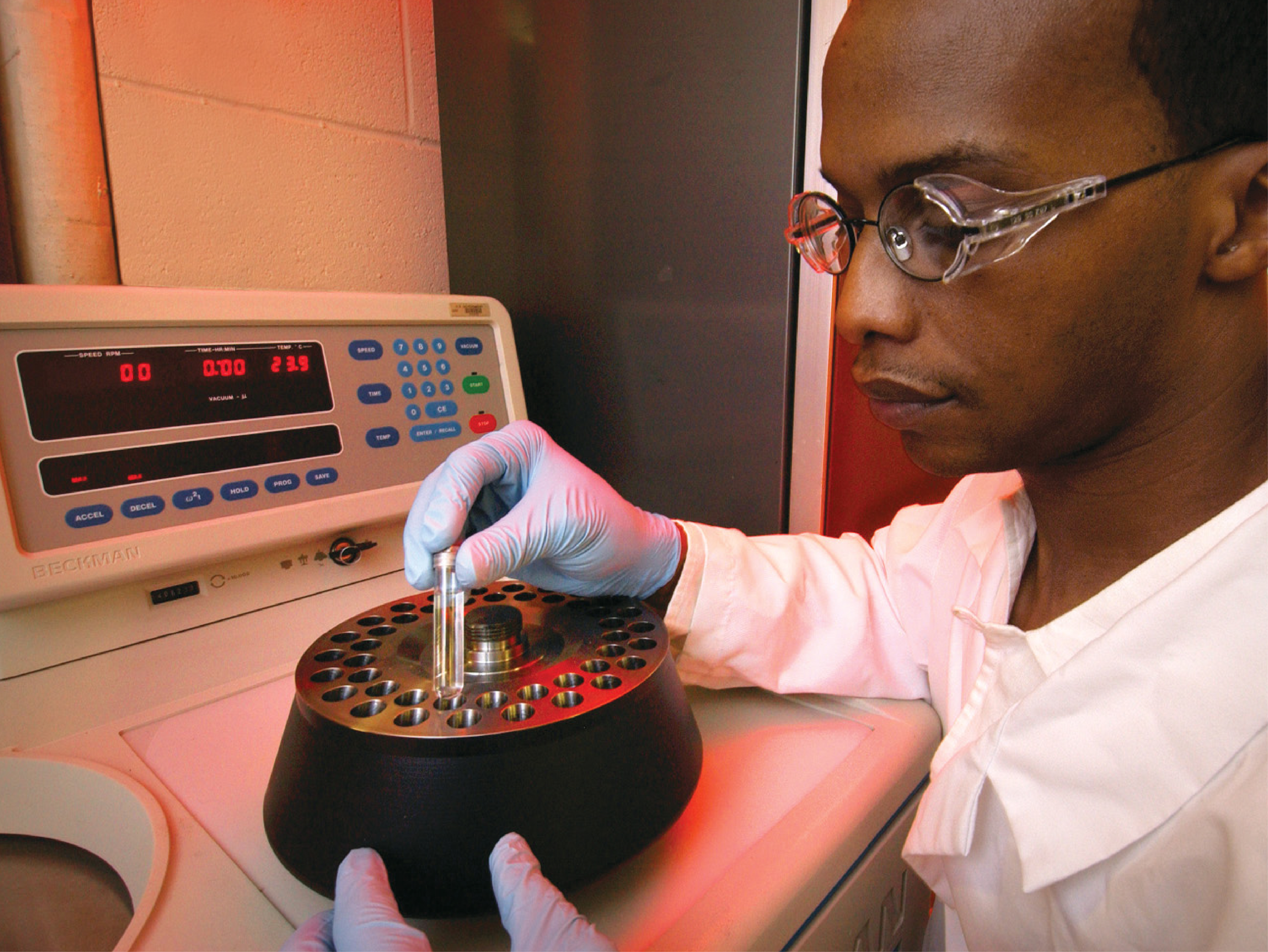 A scientist analyzes something on a plate at a biopharma company