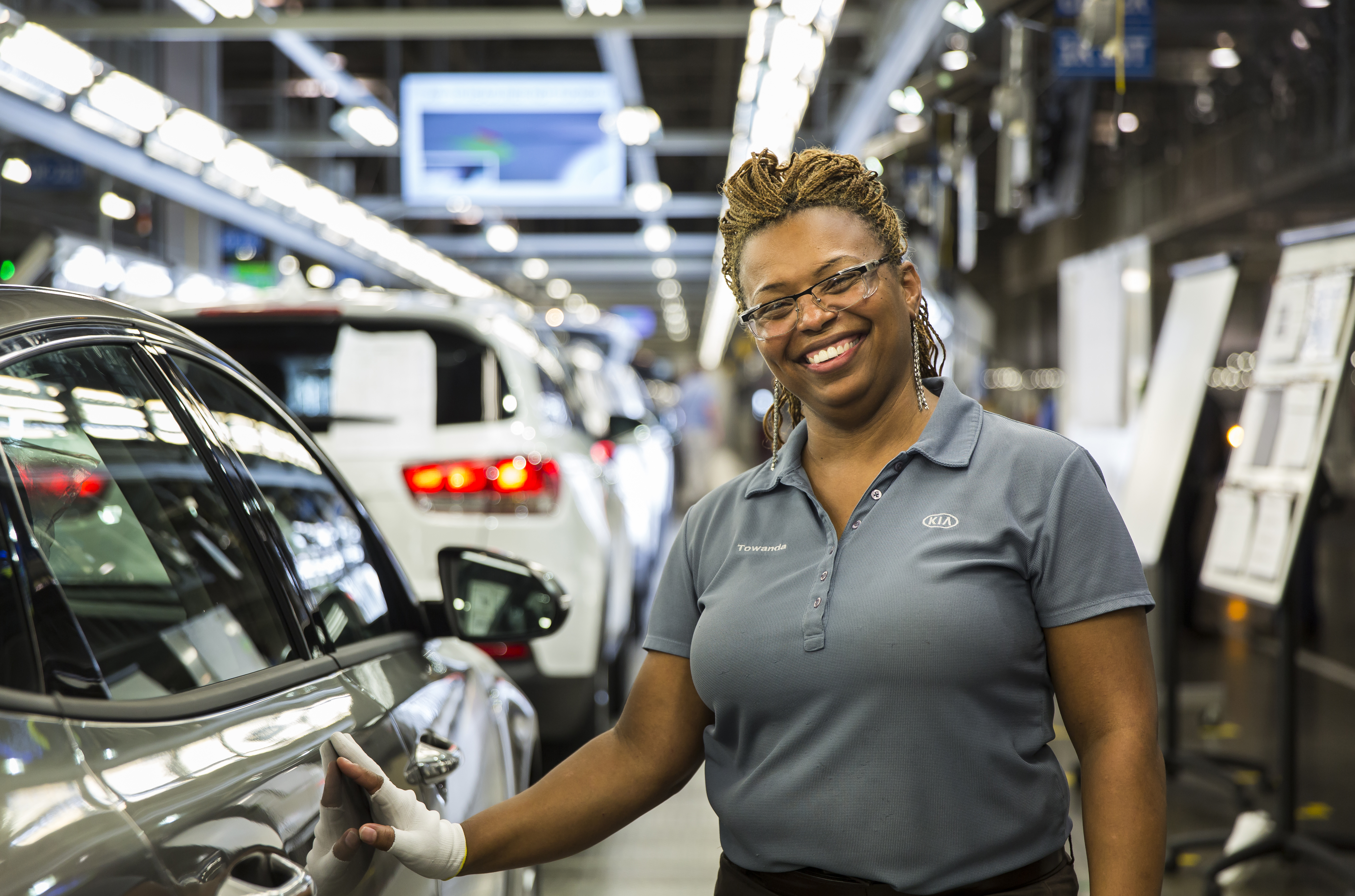 A worker standing inside an automotive factory