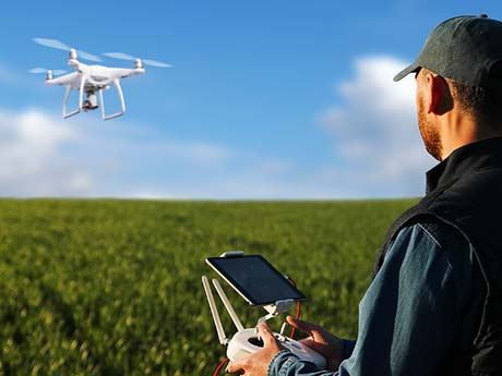 farmer with a drone over a field