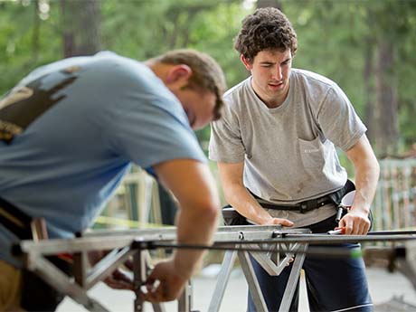 two people work on a work bench