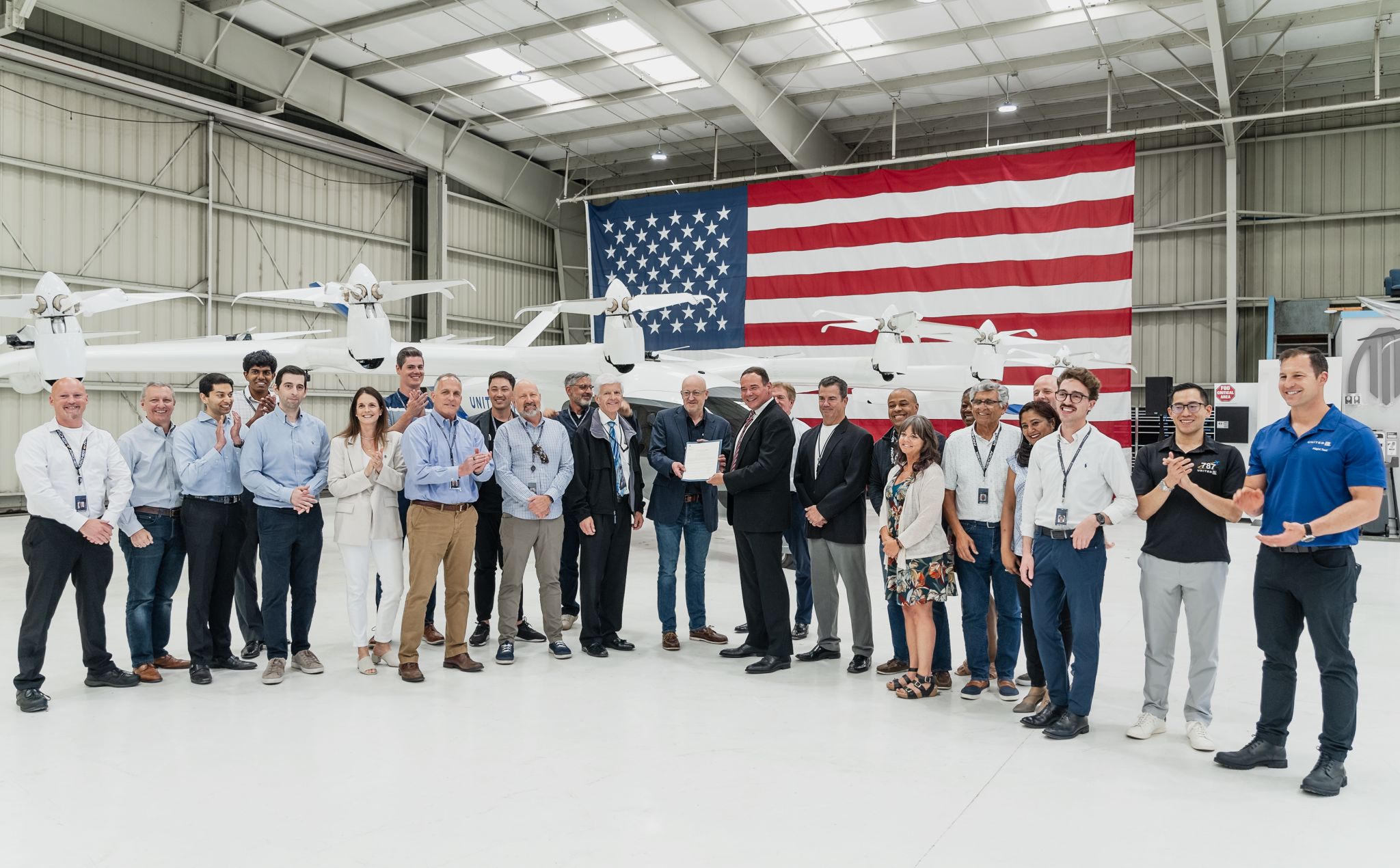 aerospace workers standing in front of an airplane