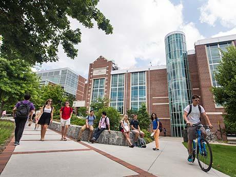 Talent Pipeline - Students at University students ride bikes a walk on path at a university