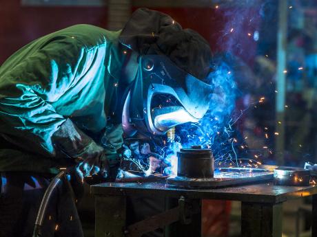 Welder welding a piece of metal 