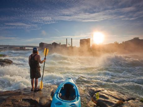 Columbus river with kayaker standing on rocks