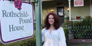 Mamie Pound in front of bed and breakfast
