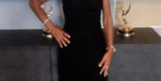janice scott standing with two emmy awards