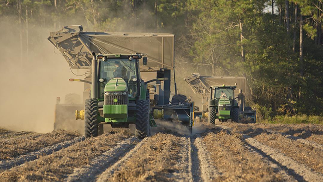 A tractor goes through fields during the Peanut Harvest in Fitzgerald, GA