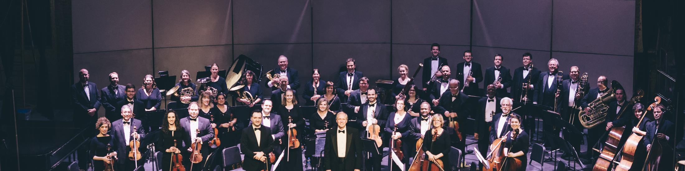 A large Orchestra performing on set in Georgia
