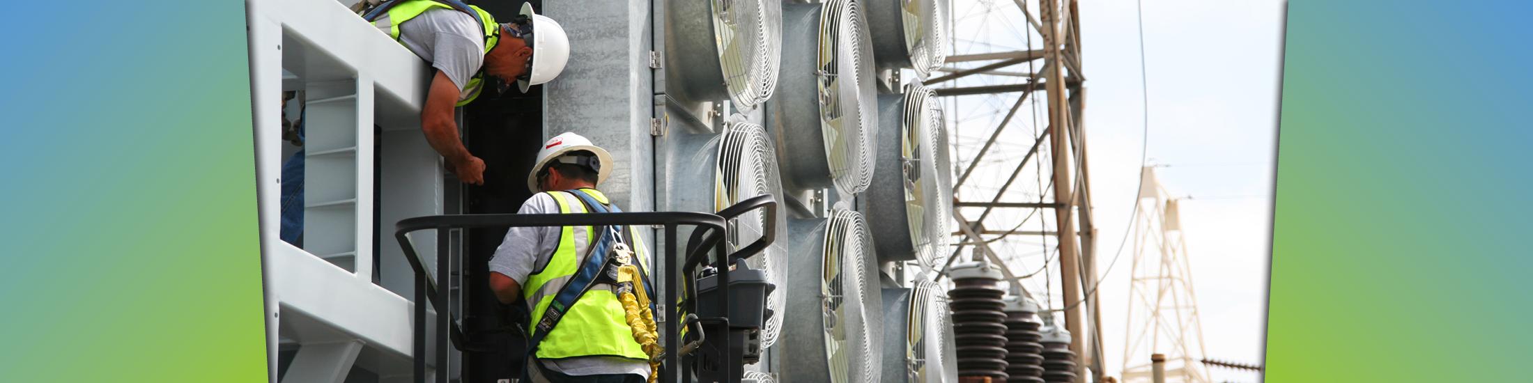 two people work on large Georgia energy storage building