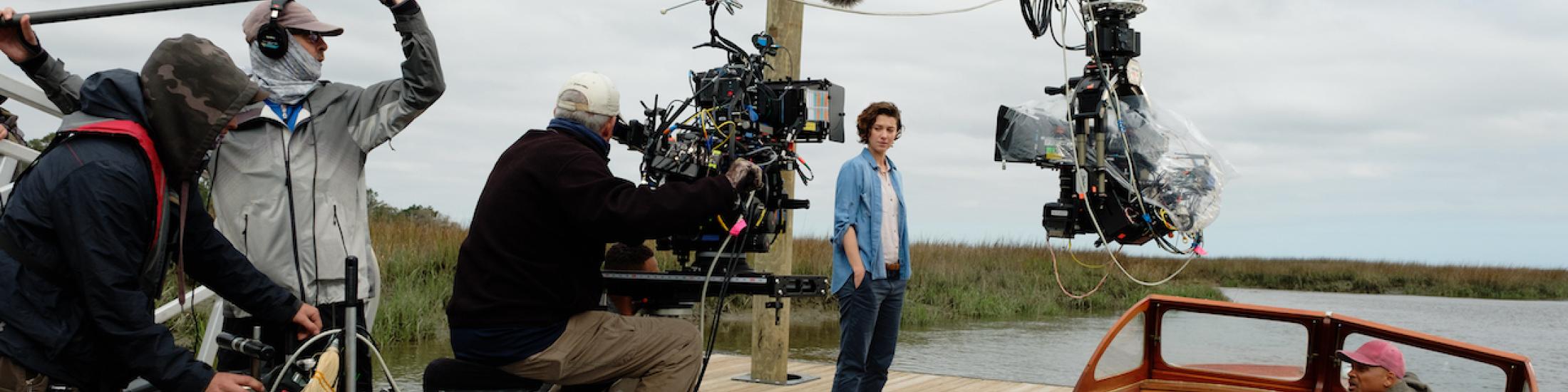 Behind the scenes photo of Mary Elizabeth Winstead and cast filming outdoors in Georgia for the movie Gemini Man