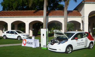 two white electric cars on display