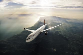 A large plane flies through the air.