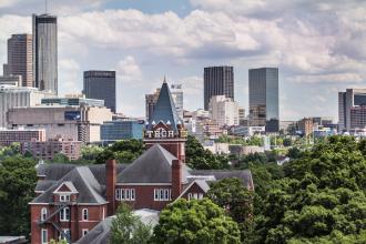 A view of georgia tech buildings and the skyline behind them