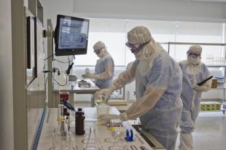 A biopharma employee works in a lab